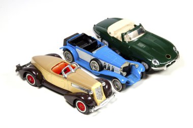 Collection of Three Toy Model Cars on White clipart