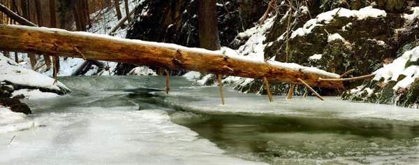 Night winter view to icicles and icy boulders into the stream. — Stock Photo, Image