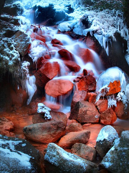 Stream of mineral water in deep freeze. Long exposure in night.