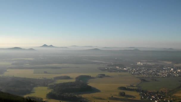 View from the hill down to countryside with light mist. Large fields, forests, villages and hills within morning sunrise. — Stock Video