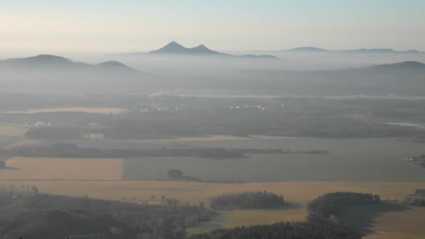 View from the hill down to countryside with light mist. Large fields, forests, villages and hills within morning sunrise. — Stock Video