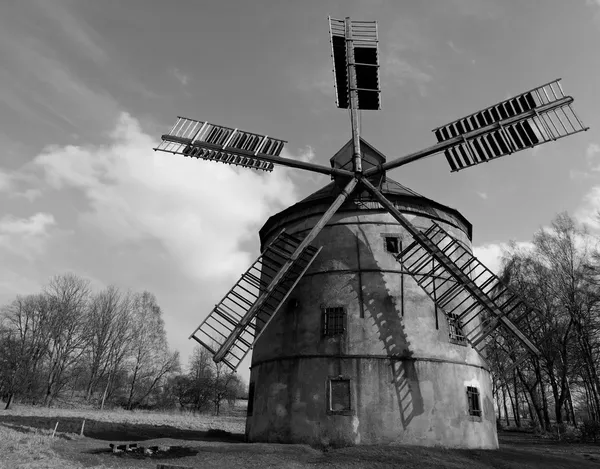 Renewal wind mill house into summer house. New red roof, repaired wind blades. Black and white photo. — Stock Photo, Image
