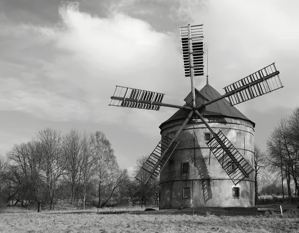 Renewal wind mill house into summer house. New red roof, repaired wind blades. Black and white photo. — Stock Photo, Image