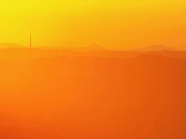 Magnificent orange fogy daybreak, beautiful spring misty sunrise above valley and hills. — Stock Photo, Image
