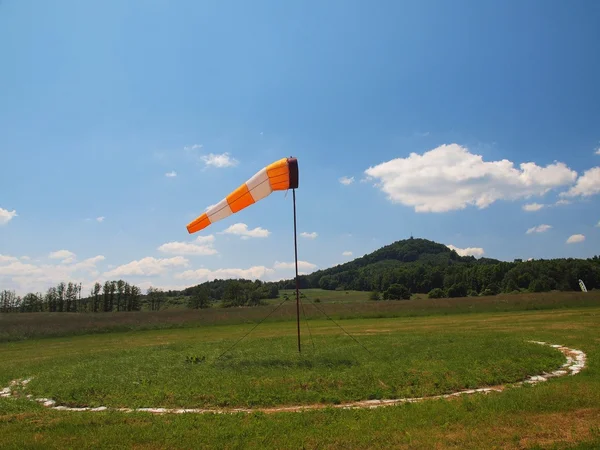 Summer hot day on sport airport with Abandoned  windsoc, wind is blowing and windsock is moving — Stock Photo, Image