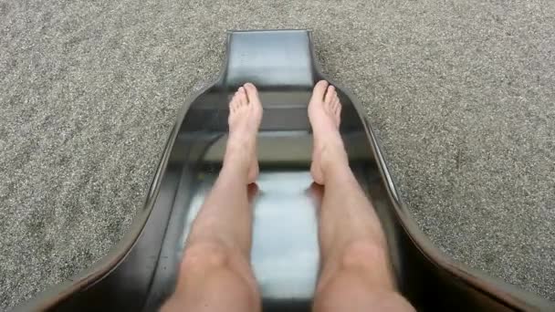 Legs of boy on metal slider. Movement of body. — Stock Video