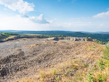 Open clinkstone or phonolite quarry. Black basalt stones mine. Industry of basalt stone, stony quarry