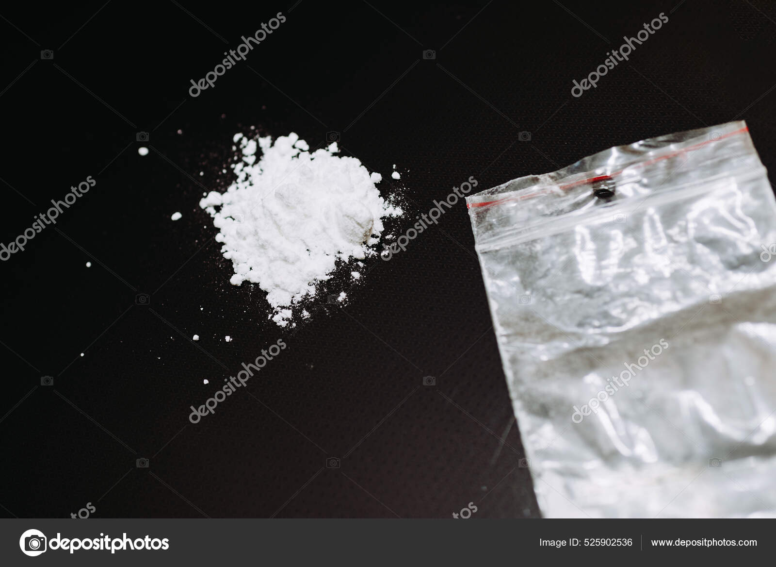 close up pile of cocaine in paper and vodka on black background