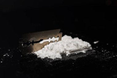 Razor Blade uyuşturucu tozunda yansıma siyah arka planda. Boşluğu kopyala.