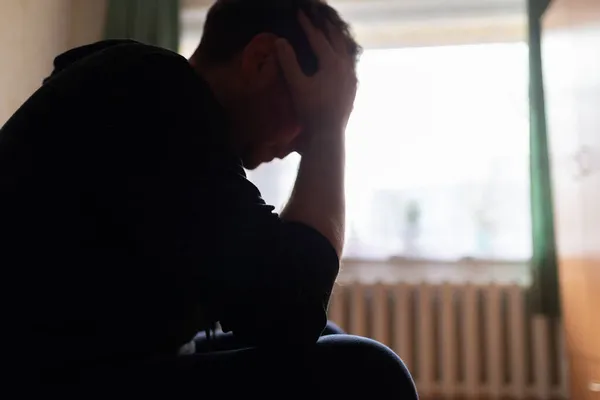 Silhouette Depressed Man Sitting Couch Hands Head Dark Bedroom Low — Stock Photo, Image