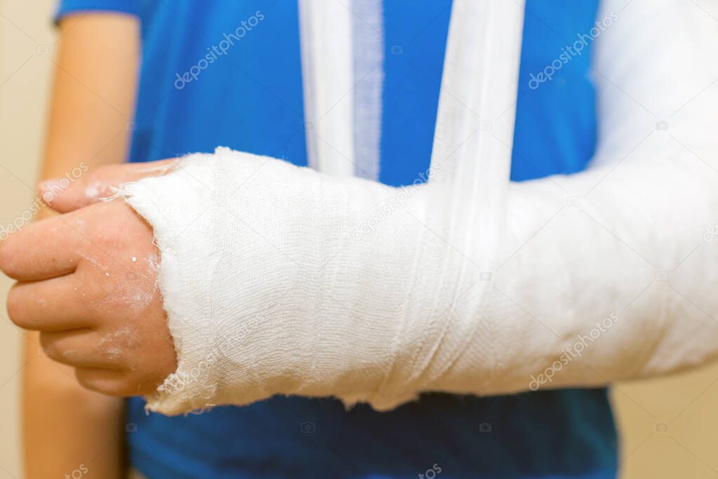 Boy, child,kid with plastered hand on white background.Close-up.
