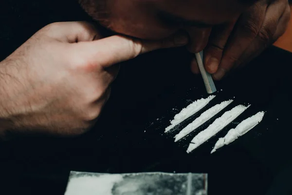 麻薬中毒者 薬物乱用 薬を飲んでいる男 コカインの白色の粉末の線を曲げて 閉じて トーン — ストック写真