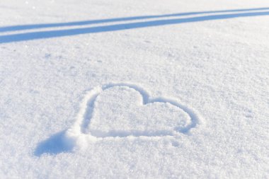 Bir el taze karda kalp şeklinde çizilmiş. Üst görünüm, yakın plan, boşluğu kopyala.