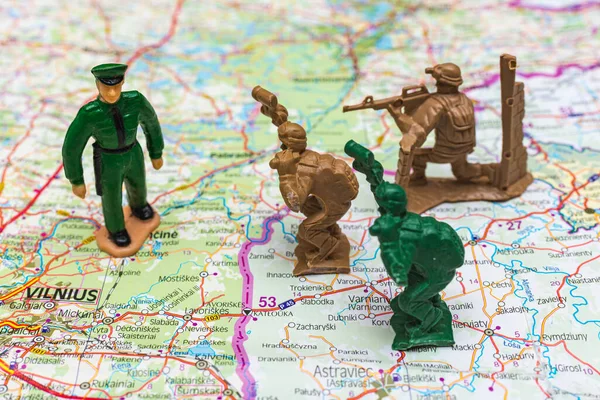 War and military concept. Group of miniature soldiers toy on belarus lithuanian map