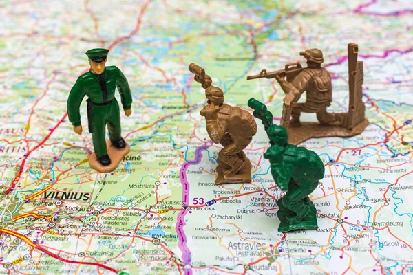 War and military concept. Group of miniature soldiers toy on belarus lithuanian map