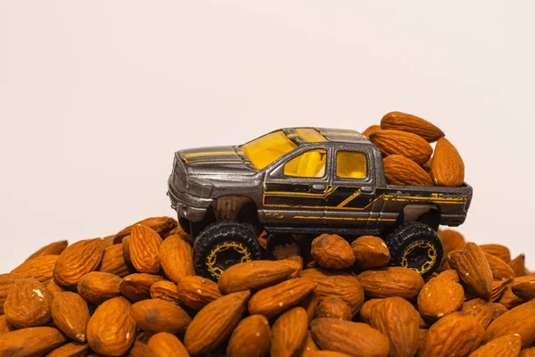 Miniature Toy Car Truck Pile Almond Nuts White Background Truck — Foto Stock
