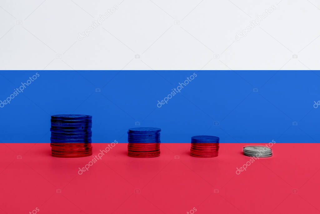 Stacks of coins against flag of Russia. Economic regression of finance of Russian Federation, negative impact of western sanctions on Russia financial system.Double exposure