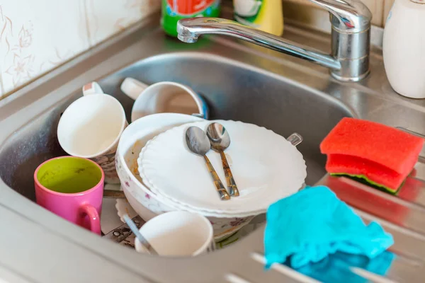 A lot of dirty dishes in the sink.Not washed dishes in the sink.Dishwashing liquid concept.
