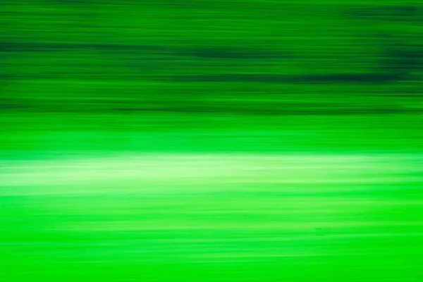 Abstract Green trees motion blurred green leaves background.