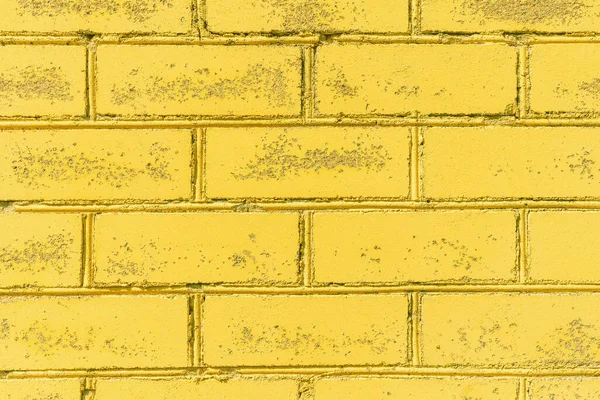 Yellow wall brick background texture photo.Background yellow brick wall.