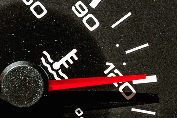 Temperature gauge in a car dashboard showing hot.close up.