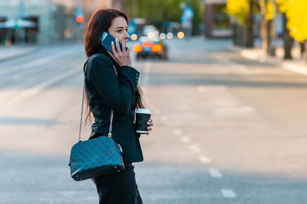 Молодая Деловая Женщина Разговаривает Телефону Держа Стаканчик Кофе Переходя Улицу — стоковое фото