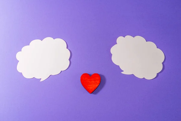 White clouds,heart for Valentine\'s day concept.Communication red heart between two clouds. Purple,veri peri background.Place for your text. Copy space.