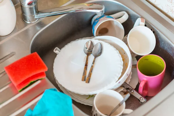 A lot of dirty dishes in the sink.Not washed dishes in the sink.Dishwashing liquid concept.