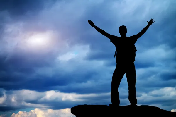 Silhouette of a man on a mountain top. — Stock Photo, Image