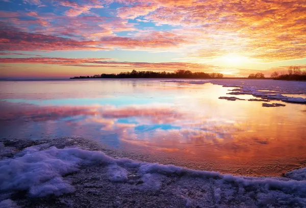 Winter landscape with lake and sunset fiery sky. Composition of — Stock Photo, Image