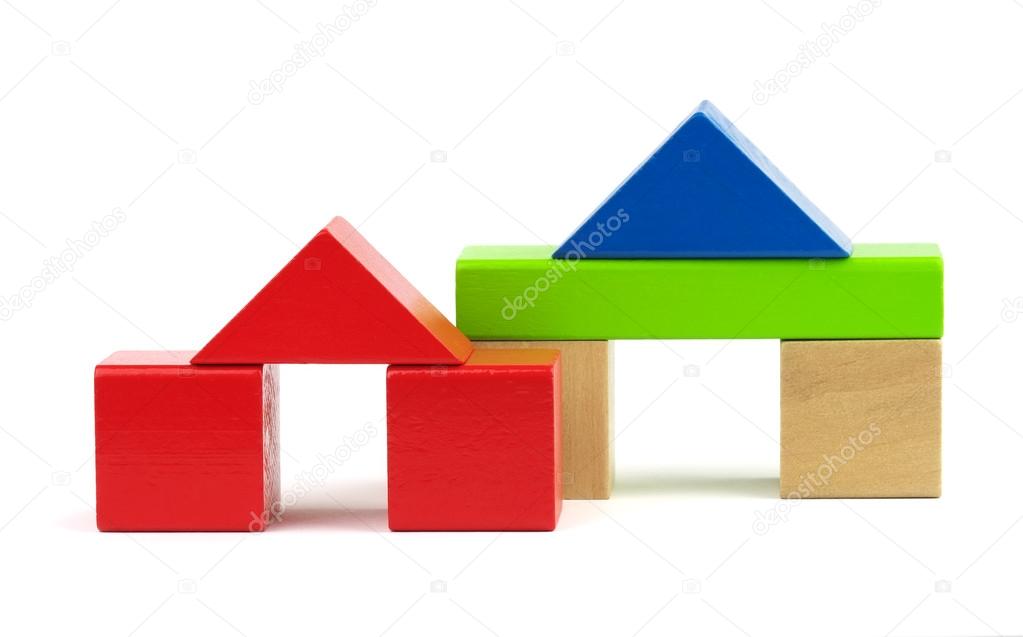 Houses made from toy wooden colorful building blocks