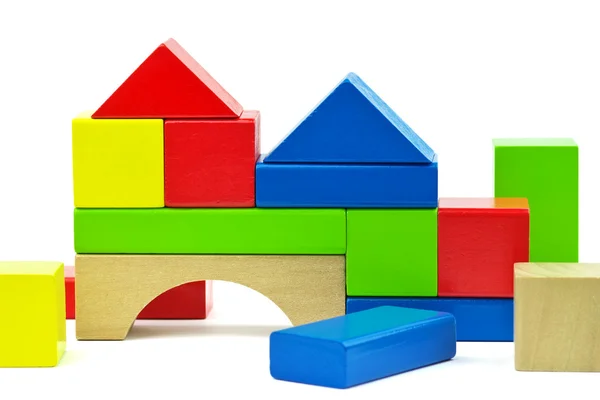 House made from toy wooden colorful building blocks on a white b — Stock Photo, Image