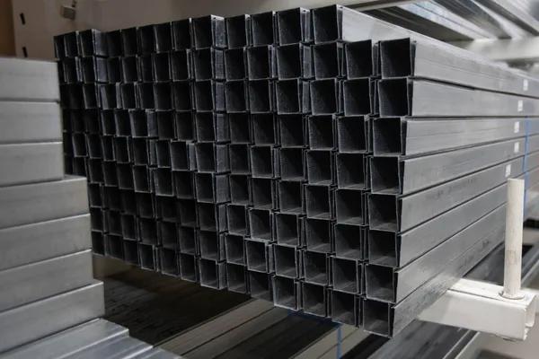 Stack of galvanized rectangular steel pipes for building materials. Production and construction of drywall walls. the concept of the construction. — Stock Photo, Image