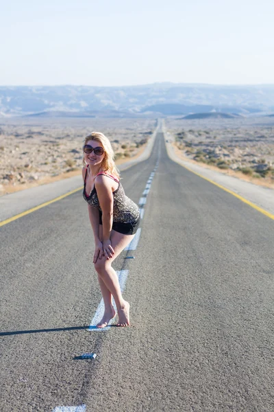 Beautiful young woman on a road . — Stock Photo, Image