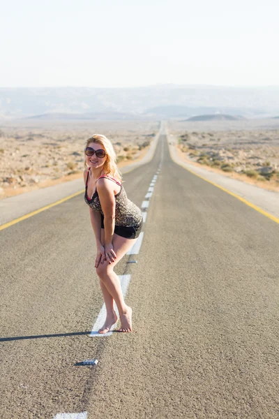 Beautiful young woman on a road . — Stock Photo, Image
