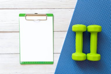 Ahşap arka planda dambıllar. Sağlıklı yaşam tarzı kavramı.