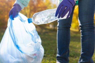 Kadın bir gönüllü doğadaki plastik çöpleri temizliyor..