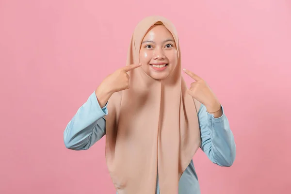 カジュアルなヒジャーブを身に着けている美しいイスラム教徒の女性は陽気な笑みを浮かべて指の歯と口で指す 歯の健康の概念 — ストック写真