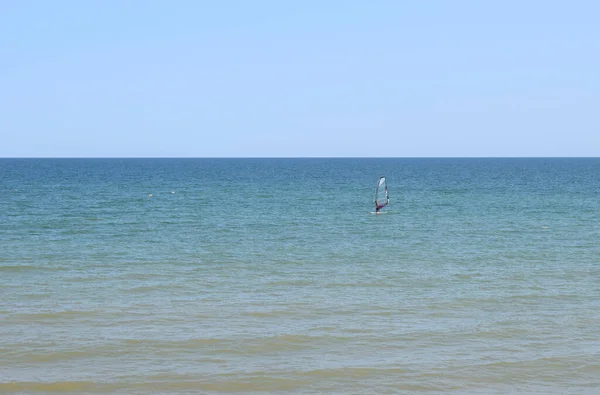 Man Engaged Windsurfing Background Blue Sea Sky Man Rides Board — Stock Photo, Image