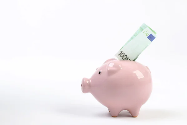 Piggy bank style money box with one hundred euro falling into slot on white background — Stock Photo, Image