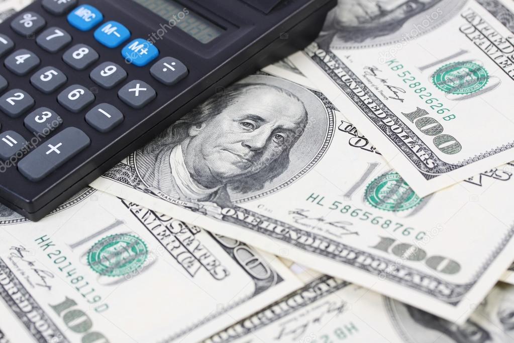 Calculator on money american hundred dollar bills - horizontal