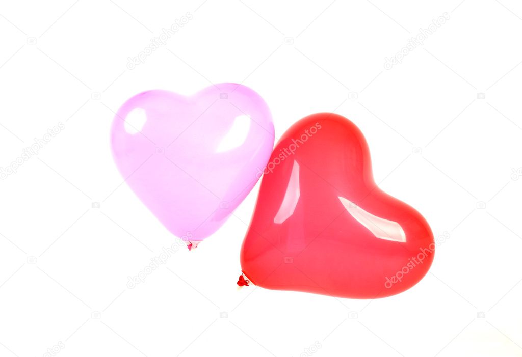 Two hearts shaped ballons over white background