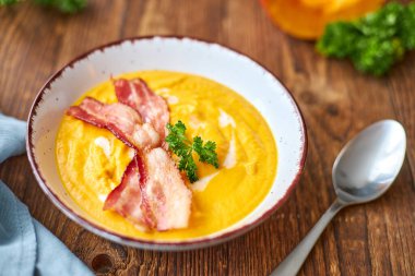 Kremalı ve pastırmalı taze balkabağı çorbası, maydanozla süslenmiş. Sonbahar yemeği. Mevsimlik çorba