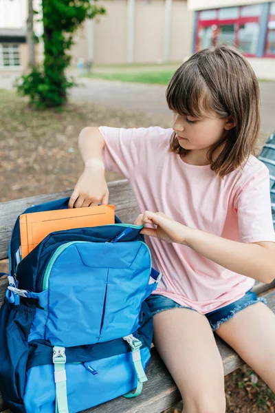 Teenage Girl Sits School Yard Takes Textbooks Out Her Backpack — Fotografia de Stock