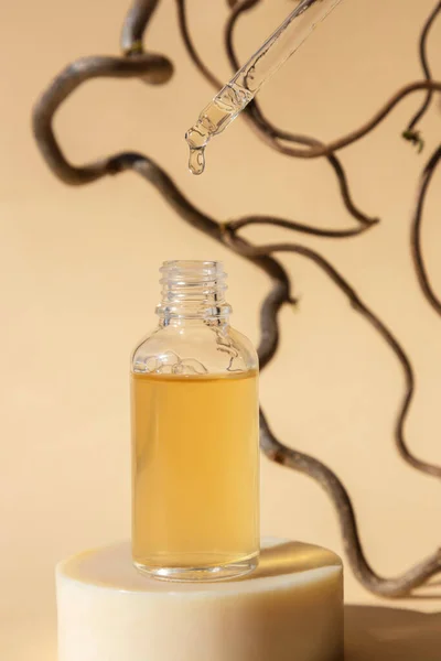 Open cosmetic bottle with a pipette on a beige background with natural ingredients. The concept of natural bio cosmetics. Organic spa cosmetics.