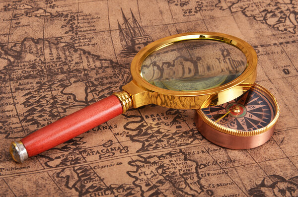 Ancient map and magnifying glass