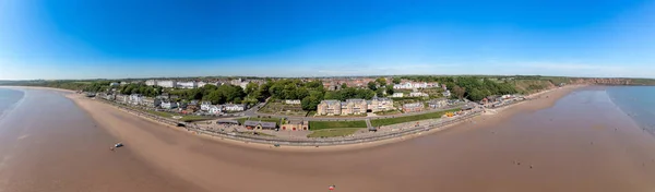 Aerial panoramic photo of the seaside village of Filey in the UK showing a wide view image of the sea front and coastal hotels in the summer time