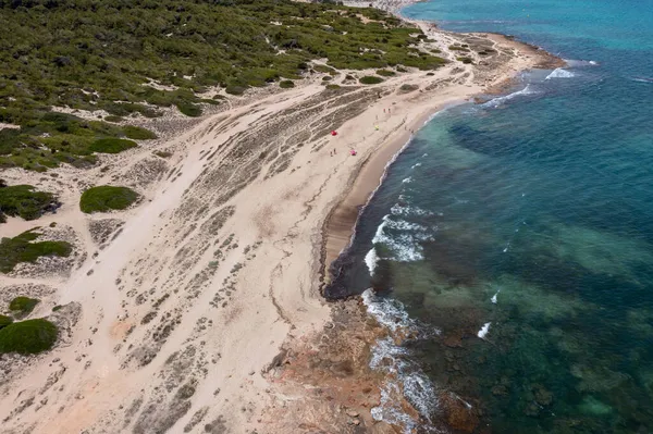 Aerial drone photo taken on the beautiful island of Majorca in Spain showing the beach and sea front and sand dunes on a bright sunny summers day