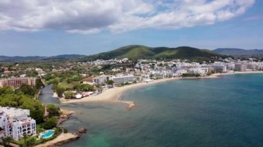 İspanya 'nın güzel İbiza adasının, Santa Eularia des Riu' da güneşli bir yaz gününde sahili ve otelleri gösteren hava aracı görüntüleri.