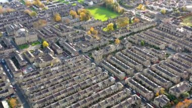 Aerial footage taken in the small town of Shipley in the City of Bradford, West Yorkshire, England showing the autumn colours of the hosing estates and roads in the town centre.